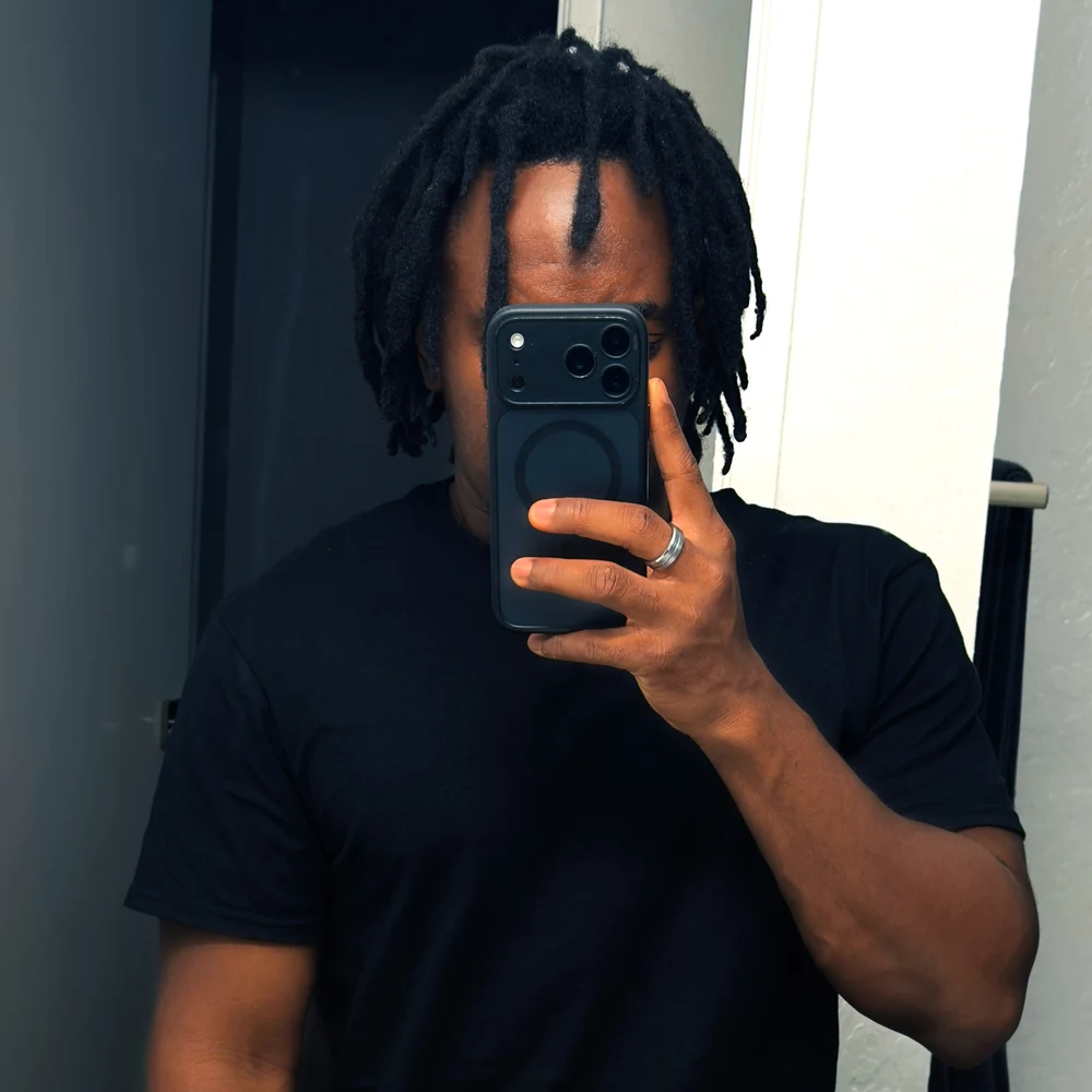 Luk in a black T-shirt taking a mirror portrait